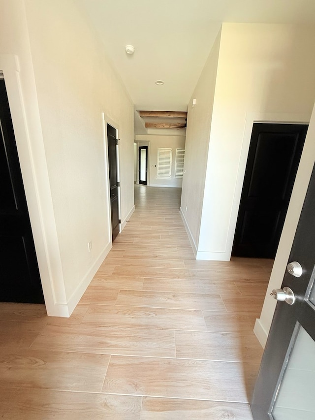 hallway with light hardwood / wood-style flooring