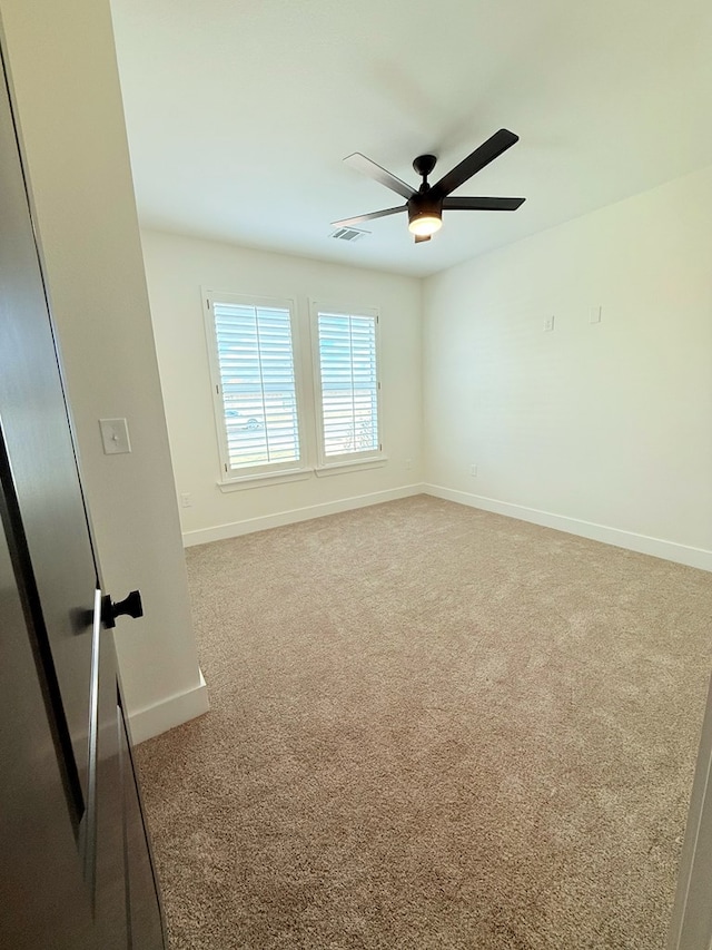 unfurnished room featuring carpet and ceiling fan