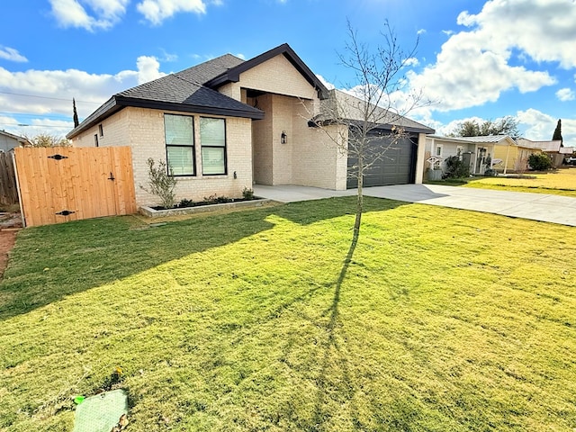 view of front of property with a front yard and a garage