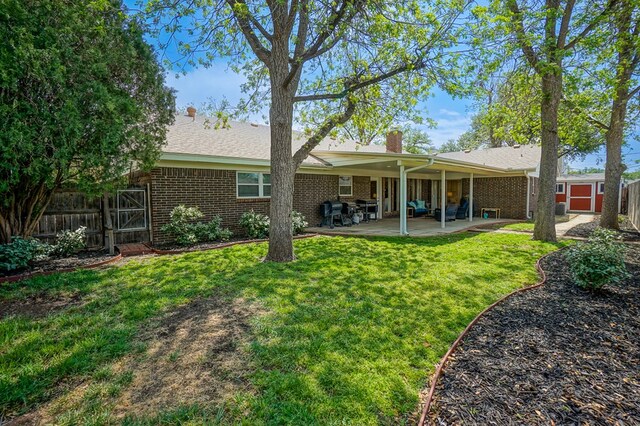 5 Bristol Ct, Midland, TX 79705 - back of house with a chimney, fence, a yard, a patio, and brick siding