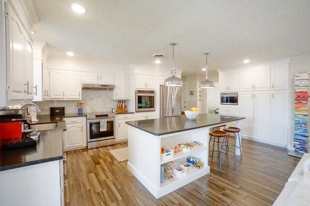 5 Bristol Ct, Midland, TX 79705 - kitchen featuring white cabinets, dark countertops, appliances with stainless steel finishes, and a sink