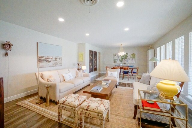 5 Bristol Ct, Midland, TX 79705 - living room with baseboards, a chandelier, wood finished floors, and recessed lighting