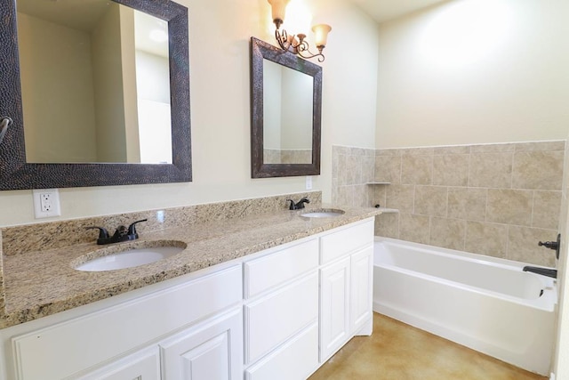 bathroom with vanity, a bathing tub, and a notable chandelier