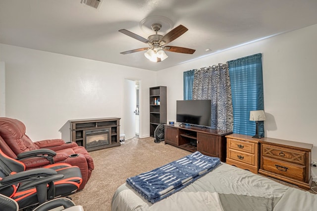 bedroom with a fireplace and ceiling fan