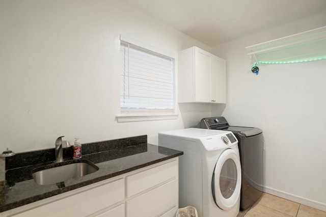 clothes washing area with cabinets, separate washer and dryer, sink, and light tile patterned floors