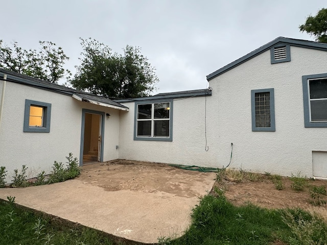 back of house with a patio