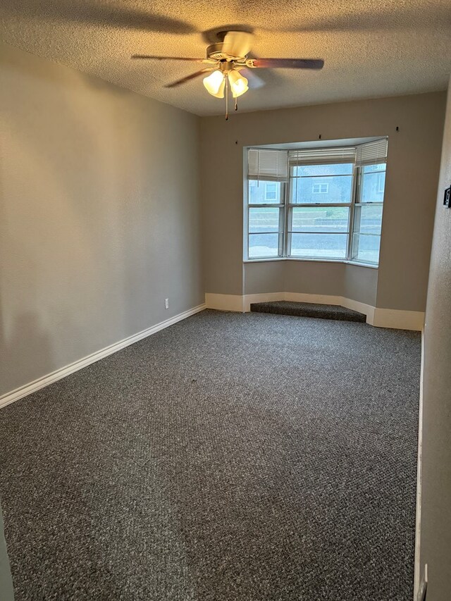 carpeted empty room featuring a textured ceiling and ceiling fan