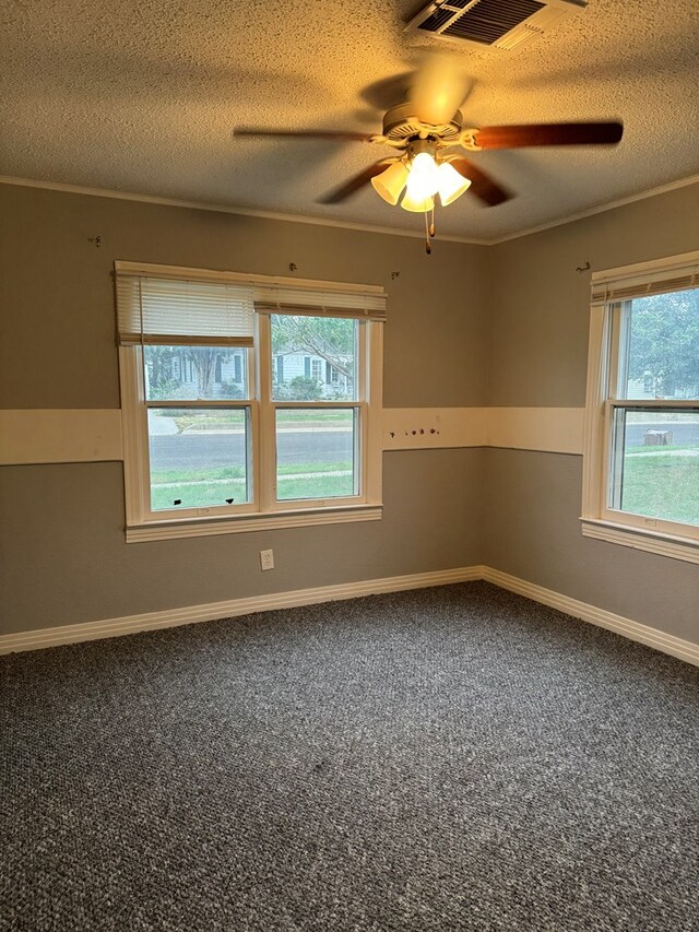 empty room with carpet, ceiling fan, crown molding, and a textured ceiling