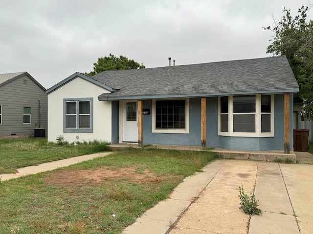 ranch-style house with central air condition unit and a front lawn