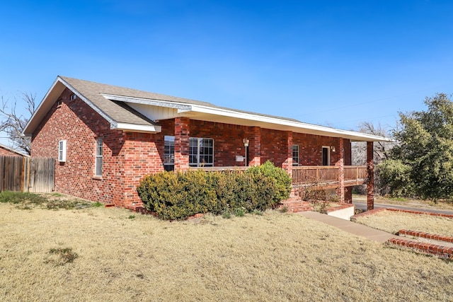 ranch-style house featuring a porch and a front lawn