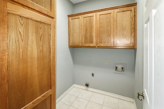 washroom featuring hookup for a washing machine, light tile patterned flooring, electric dryer hookup, and cabinets