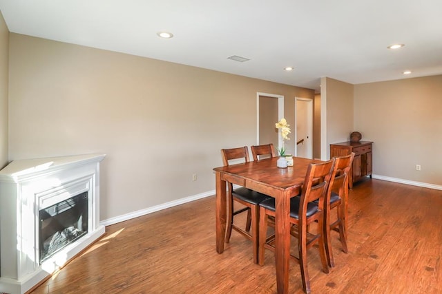 dining space with hardwood / wood-style flooring