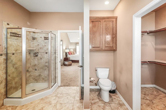 bathroom featuring an enclosed shower, tile patterned floors, and toilet