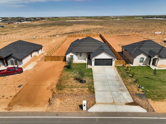 13227 E County Rd 110, Midland, TX 79706 - ranch-style house featuring roof with shingles, fence, brick siding, driveway, and a garage