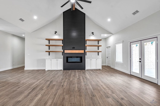 13227 E County Rd 110, Midland, TX 79706 - unfurnished living room featuring visible vents, wood finished floors, ceiling fan, and high vaulted ceiling
