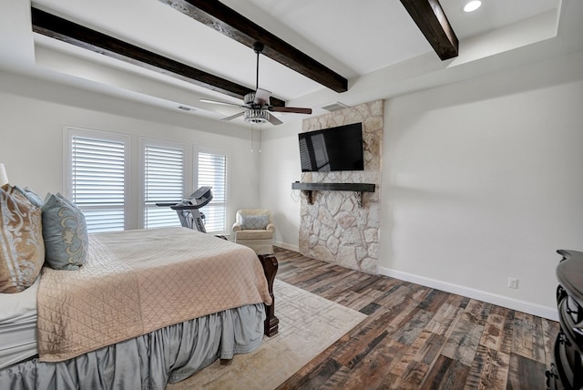 bedroom with visible vents, ceiling fan, baseboards, beam ceiling, and wood finished floors