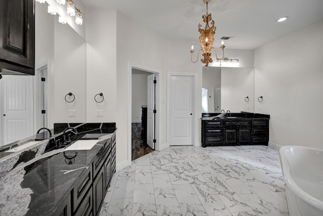 full bath with visible vents, a freestanding tub, two vanities, a sink, and marble finish floor