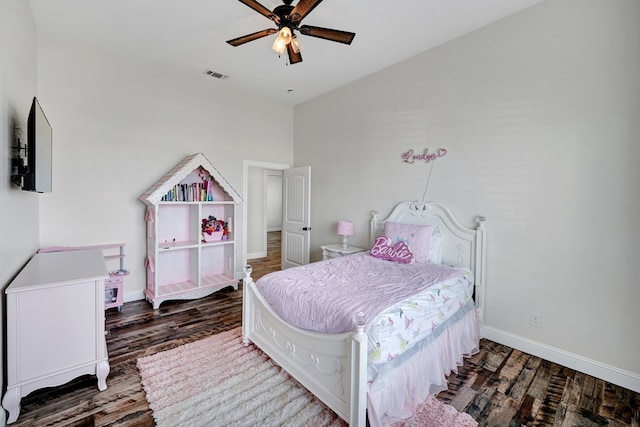 bedroom with ceiling fan, wood finished floors, visible vents, and baseboards