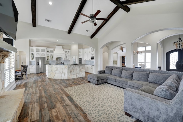 living room featuring beam ceiling, a ceiling fan, dark wood-style flooring, and high vaulted ceiling