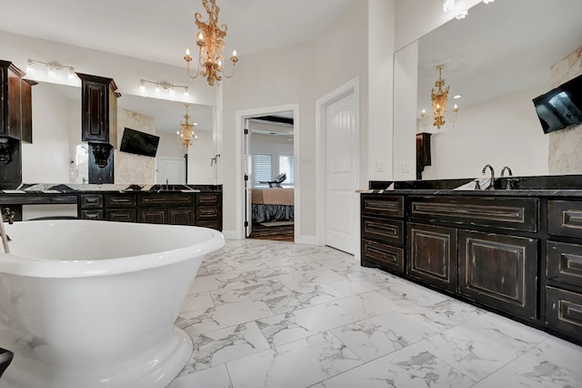 bathroom featuring connected bathroom, a notable chandelier, a soaking tub, marble finish floor, and vanity