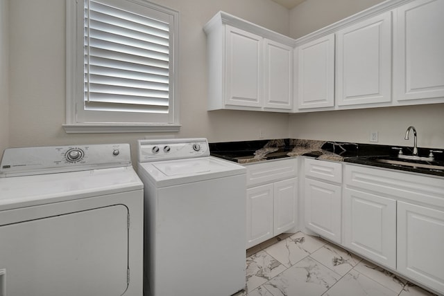 washroom featuring washer and dryer, wet bar, cabinet space, marble finish floor, and a sink