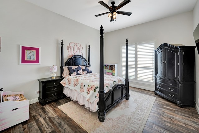 bedroom with a ceiling fan, baseboards, and dark wood-style flooring