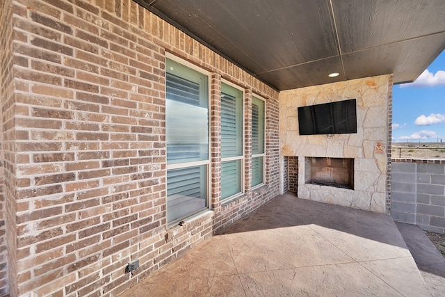 view of patio with a fireplace