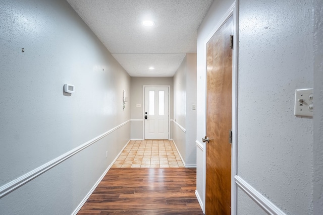 doorway featuring hardwood / wood-style floors and a textured ceiling