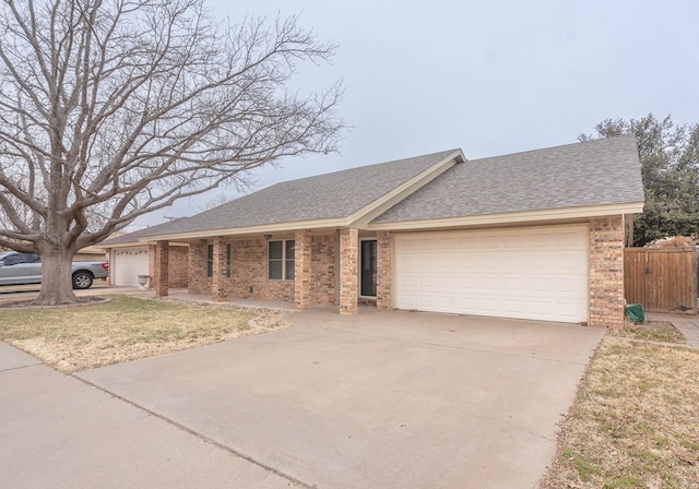 single story home featuring a garage and a front yard