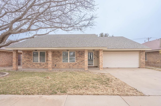 ranch-style house featuring a garage and a front lawn