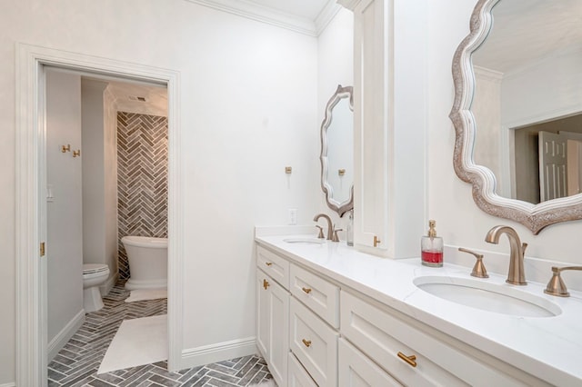 bathroom featuring baseboards, toilet, crown molding, and a sink