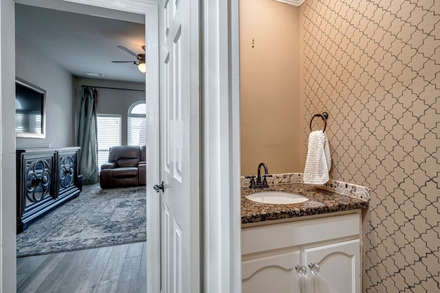 bathroom featuring vanity, a ceiling fan, and wood finished floors