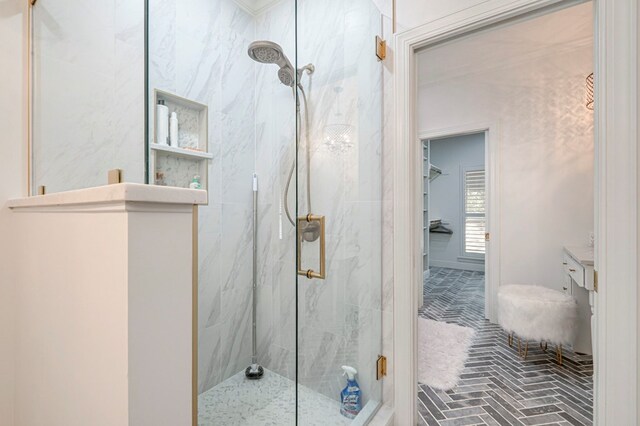 full bathroom with vanity, brick floor, and a marble finish shower