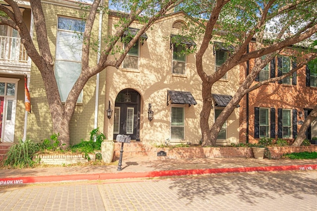 view of property with brick siding