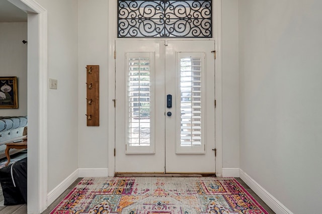 foyer with baseboards and french doors