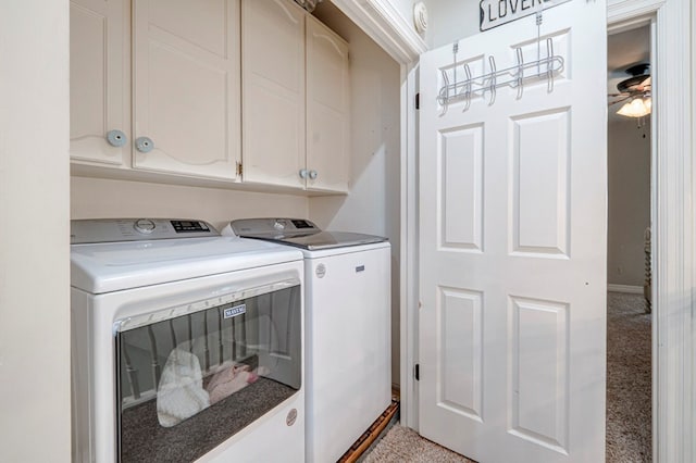 laundry area featuring independent washer and dryer, a ceiling fan, cabinet space, and baseboards