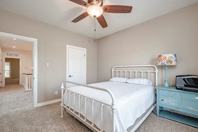 bedroom with baseboards, a ceiling fan, and light carpet