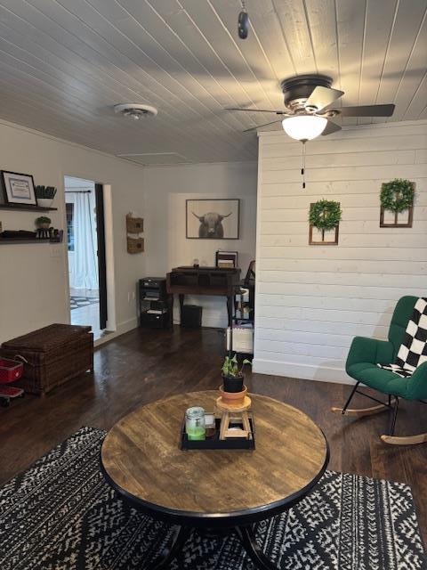 living room with dark hardwood / wood-style floors, ceiling fan, wood ceiling, and wooden walls