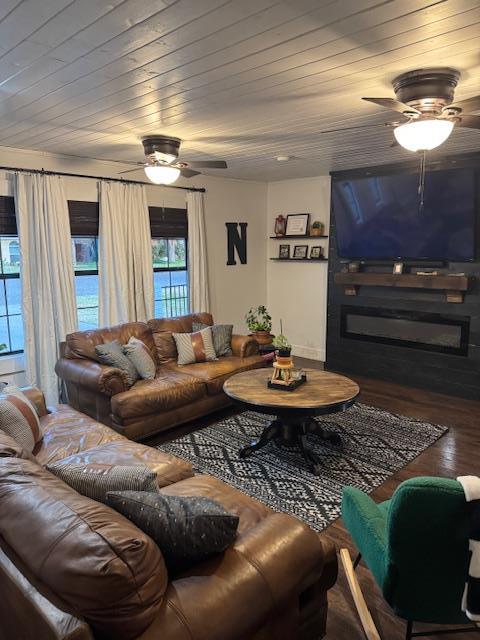 living room featuring dark hardwood / wood-style flooring and wood ceiling