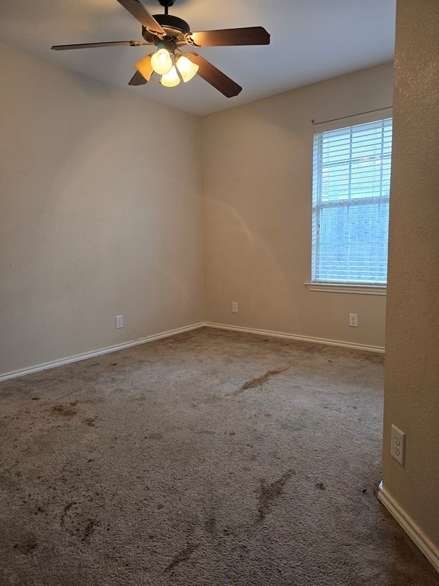 unfurnished room with carpet flooring and ceiling fan