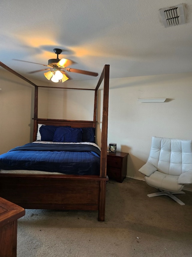 bedroom with carpet flooring, ceiling fan, and a textured ceiling