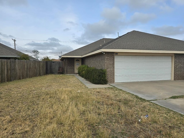 view of side of home featuring a yard and a garage