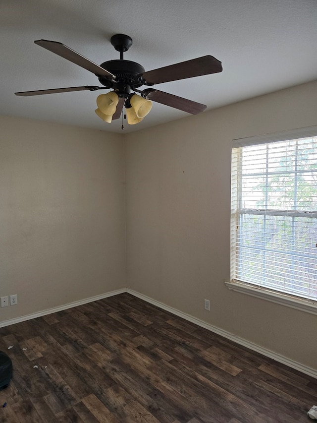 spare room featuring ceiling fan and dark wood-type flooring