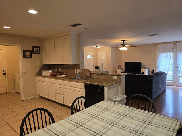 kitchen with ceiling fan, sink, light tile patterned floors, black dishwasher, and white cabinetry