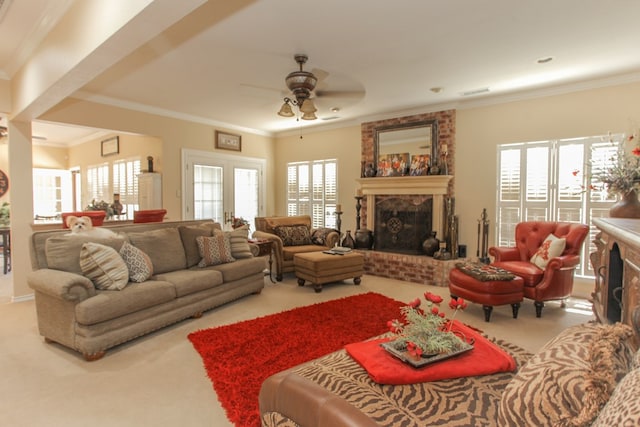 living room featuring carpet floors, a brick fireplace, ceiling fan, and ornamental molding