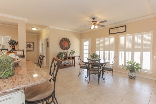 dining room with light tile patterned floors, a wealth of natural light, ornamental molding, and ceiling fan