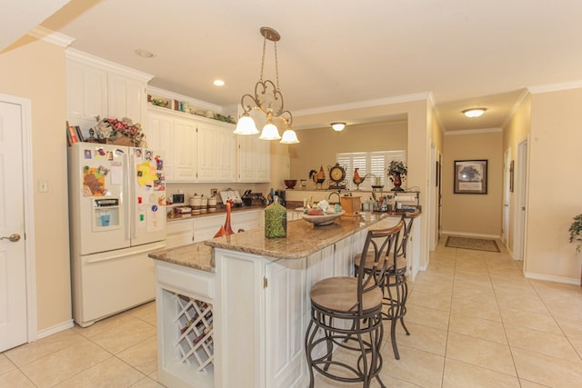 kitchen featuring light stone counters, crown molding, a kitchen island, and white refrigerator with ice dispenser