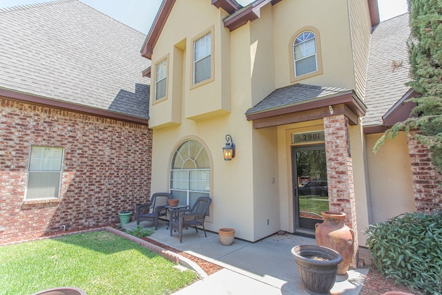 property entrance featuring a patio