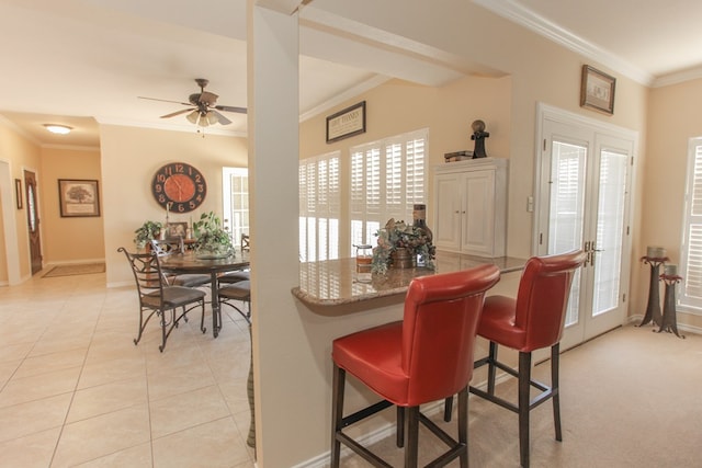 dining space featuring crown molding, french doors, and ceiling fan