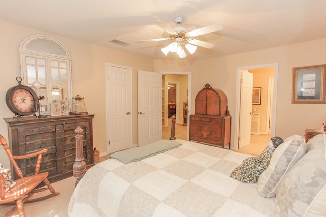 bedroom featuring carpet flooring, ceiling fan, a textured ceiling, and connected bathroom